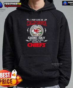 Fan wearing a Kansas City Chiefs hoodie, showing loyalty on game day despite living in California.