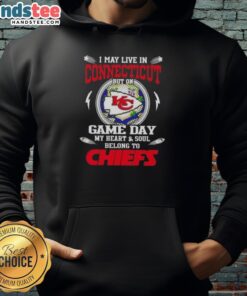 Fan in Kansas City Chiefs hoodie, showcasing team spirit on game day, despite living in Connecticut.