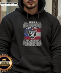 Person wearing a Raiders hoodie, showcasing team pride in Georgia on game day, with a spirited expression.