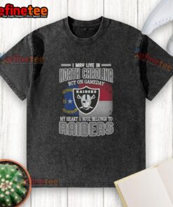 Good I May Live in North Carolina But On Gameday My Heart and Soul Belongs to Raiders washed t-shirt displayed on a hanger.