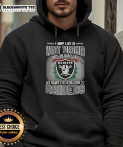 Person wearing a Raiders hoodie with 'Good I May Live In West Virginia But On Gameday My Heart Belongs To Raiders' design.