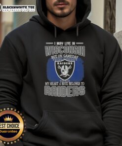 Person wearing a Raiders hoodie, showcasing team pride while living in Wisconsin on game day.