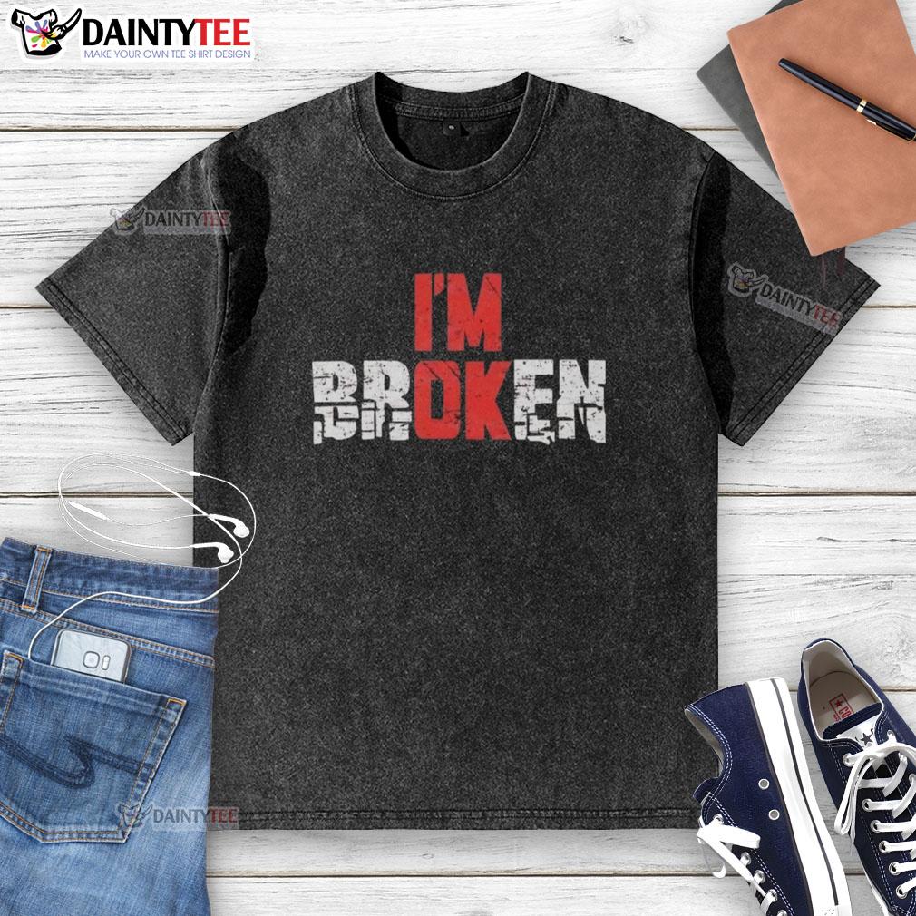 good-im-broken-emotional-quote-graphic-washed-t-shirt Emotional quote graphic on a washed t-shirt, featuring 'Good, I'm Broken' in stylish typography.
