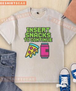 Good insert snacks to continue washed t-shirt displayed with colorful snacks on a table, promoting healthy choices.