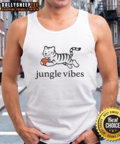 Model wearing a Good Jungle Vibes Run Wild Tiger Tank Top in a lush green jungle setting, showcasing a vibrant design.