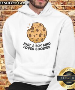 Boy wearing 'Good Just A Boy Who Loves Cookies' hoodie, smiling with cookies in hand, showcasing fun and playful style.