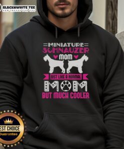 Miniature Schnauzer mom wearing a cool hoodie, showcasing her unique style and love for her furry friend.