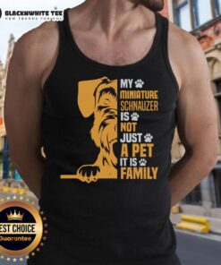Miniature Schnauzer wearing a tank top that says 'Not Just a Pet, Its Family,' showcasing the bond between pets and family.