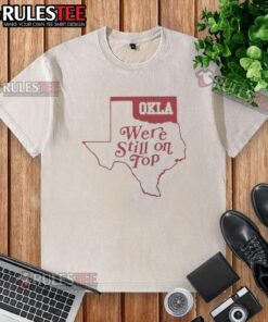 Good Oklahoma We're Still On Top map graphic on a washed t-shirt, perfect for Oklahoma pride and casual wear.