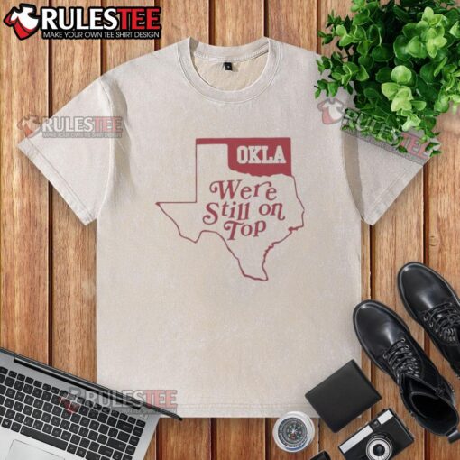 Good Oklahoma We're Still On Top map graphic on a washed t-shirt, perfect for Oklahoma pride and casual wear.