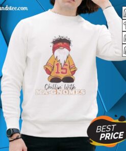 Patrick Mahomes in a Kansas City Chiefs sweatshirt, relaxing with garden gnomes, showcasing team spirit and fun.