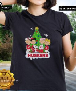 Good Peanuts characters on a Nebraska Cornhuskers Christmas ladies tee, perfect for holiday sports fans.