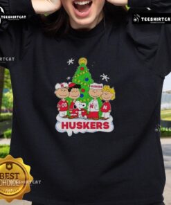 Alt Text: Good Peanuts characters Christmas sweatshirt featuring Nebraska Cornhuskers design, perfect for holiday cheer.