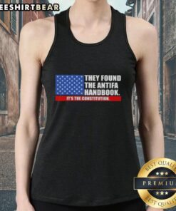 Woman wearing a US flag tank top featuring 'Good, they found the handbook: It's the Constitution' design.