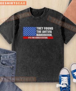 Washed t-shirt featuring the US flag and the phrase 'Good, They Found The Handbook, It's The Constitution'
