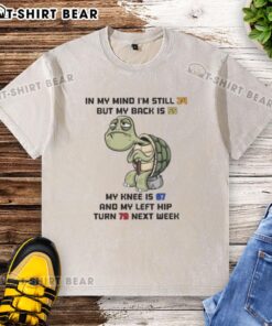 Funny washed t-shirt featuring 'Good Turtle' design, humorously stating age differences in body parts.