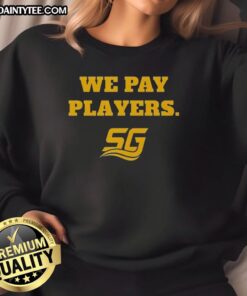 Alt Text: Happy Chad Powers wearing a We Pay Players sweatshirt while coaching with Coach Byrd, showcasing team spirit and style.