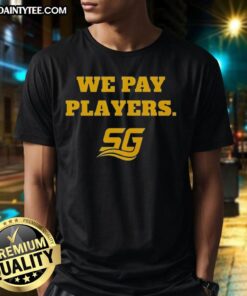 Alt Text: Happy Chad Powers wearing a We Pay Players T-shirt while coaching, showcasing team spirit and enthusiasm.