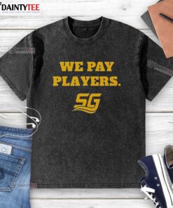 Happy Chad Powers wearing 'We Pay Players' washed t-shirt, showcasing stylish coaching vibes and team spirit.