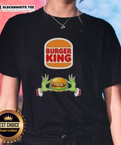 Happy Grinch hands holding a burger, celebrating Christmas in a festive Ladies Tee at Burger King.
