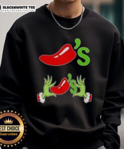 Happy Grinch hands holding chilis on a Merry Christmas sweatshirt, perfect for festive holiday celebrations.
