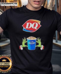 Happy Grinch hands forming a heart on a Merry Christmas T-shirt featuring Dairy Queen logo and festive design.