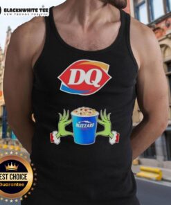 Happy Grinch hands making a heart shape in a Dairy Queen Merry Christmas tank top, celebrating festive cheer.