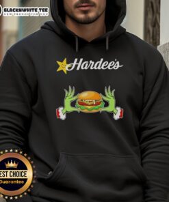 Happy Grinch hands holding a 'Love Hardee's' hoodie, perfect for a Merry Christmas celebration.