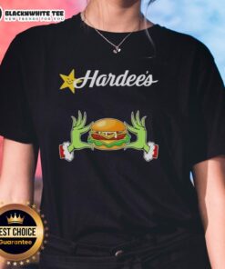 Alt Text: Happy Grinch hands holding a heart, showcasing a Merry Christmas theme on a Hardee's ladies tee shirt.