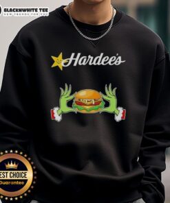Happy Grinch hands holding a heart, featuring a festive design on a Merry Christmas sweatshirt from Hardee's.