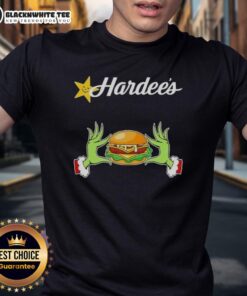 Happy Grinch hands holding a heart in a festive Hardee's Merry Christmas T-shirt design, perfect for holiday cheer.