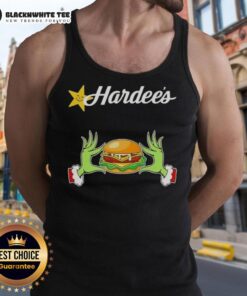Happy Grinch hands holding a Hardee's cup in a festive Merry Christmas tank top, spreading holiday cheer.
