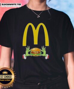 Happy Grinch hands forming a heart, showcasing a Merry Christmas ladies tee featuring McDonald's festive design.