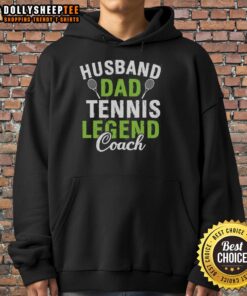 Happy husband and dad wearing a tennis legend coach hoodie, smiling on the court, showcasing family and sports passion.
