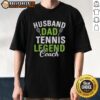 Happy husband and dad wearing a 'Tennis Legend Coach' T-shirt, showcasing pride in family and sports.