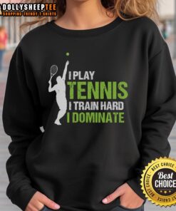 Happy player wearing 'I Play Tennis I Train Hard I Dominate' sweatshirt, showcasing passion for the sport.