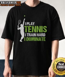 Happy player wearing 'I Play Tennis I Train Hard I Dominate' T-shirt on the court, showcasing passion for tennis.