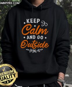 Happy 'Keep Calm and Go Outside' hoodie displayed on a wooden background, perfect for outdoor enthusiasts.