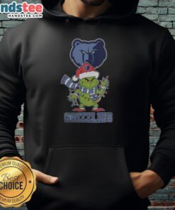 Alt Text: Happy Memphis Grizzlies fan wearing a Christmas Grinch Santa hat and holiday hoodie for 2025 festivities.