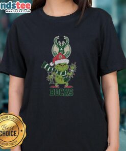 Happy Milwaukee Bucks Christmas tee featuring Grinch in Santa hat, perfect for holiday cheer in 2025.