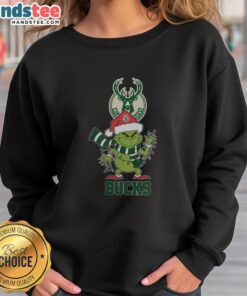 Happy Milwaukee Bucks Christmas sweatshirt featuring Grinch in Santa hat, perfect for holiday cheer 2025.
