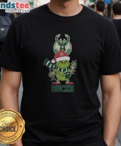 Happy Milwaukee Bucks Christmas Grinch Santa Hat Holiday 2025 T-Shirt featuring festive design and team logo.