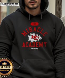 Happy NFL Kansas City Chiefs fans wearing Nahmias hoodie celebrate a victory at Miracle Academy event.
