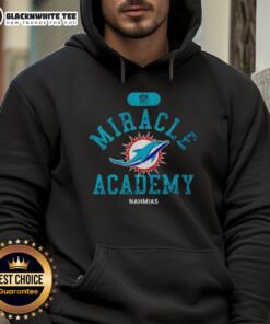Alt Text: Happy NFL Miami Dolphins fans in Nahmias hoodie celebrating a game at Miracle Academy, showcasing team spirit.
