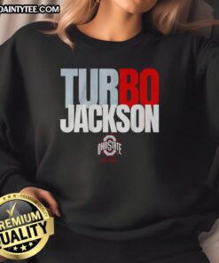 Happy Ohio State Buckeyes football fan wearing Bo Jackson Turbo sweatshirt at a game, showcasing team spirit and style.