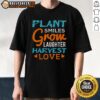 Happy Plant Smiles Grow Laughter Harvest Love T-Shirt featuring a cheerful plant graphic and vibrant colors.
