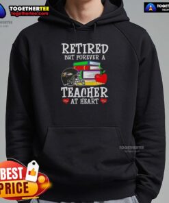 Happy retired teacher wearing a Baltimore Ravens football hoodie, showcasing love for teaching and team spirit.