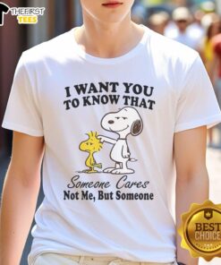 Alt Text: Happy Snoopy graphic tee featuring 'I Want You To Know That Someone Cares' message for fans of Snoopy shirts.