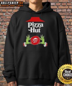 Hot Grinch hands holding a pizza slice, wearing a Merry Christmas hoodie from Pizza Hut, perfect for holiday cheer.