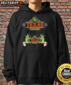 Alt Text: Hot Grinch hands holding a Texas Roadhouse hoodie, spreading Christmas cheer, perfect for holiday celebrations.